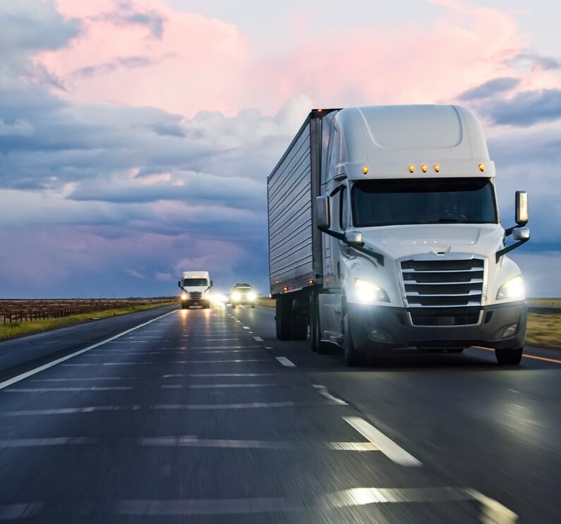 Car POV of Semi-Trucks Driving Interstate 5 Under Beautiful Clouds